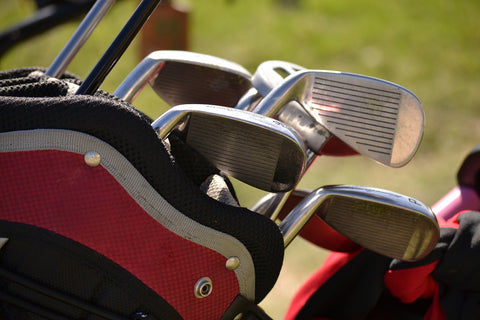 golf clubs in a golf bag displaying golf brands