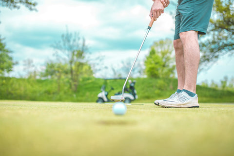 joueur de golf frappant une balle de golf avec un club de golf adapté à sa taille