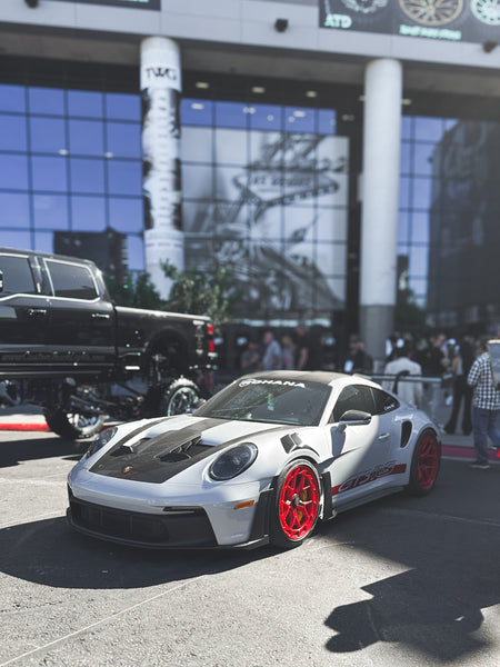 Porsche 911 GT3 RS on Rohana wheels displayed outside of the main entrance at SEMA 2023.