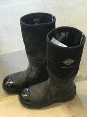 Pair of black work boots with a logo on the shaft and TUFF TOE applied on the glossy toe caps, displayed on a concrete floor.