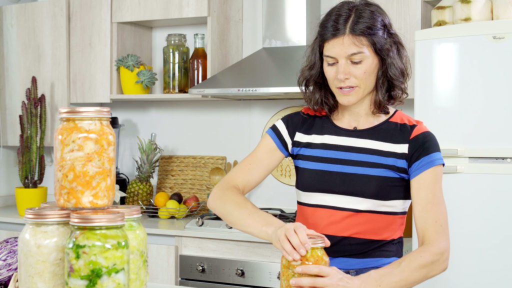 woman putting a lid on a jar