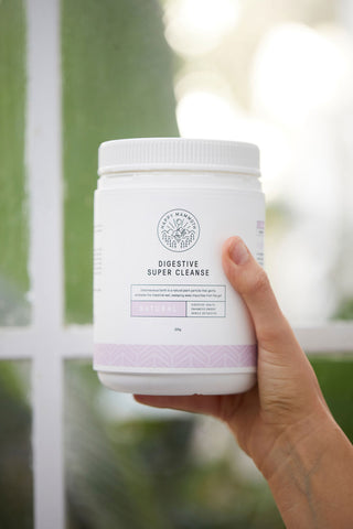 hand holding digestive super cleanse container