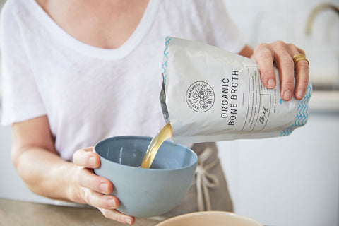 organic bone broth being poured into a bowl