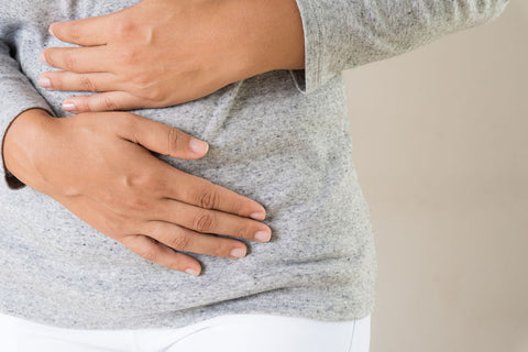 woman holding her stomach