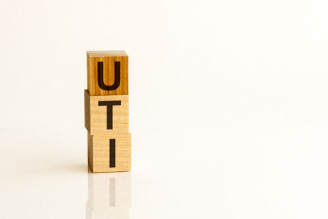 "UTI" spelled with scrabble blocks 
