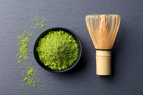 matcha and wooden whisk