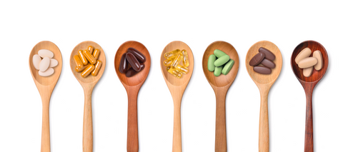 wood spoons holding pills 