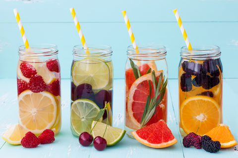 mason jars with striped straws filled with water and fruit