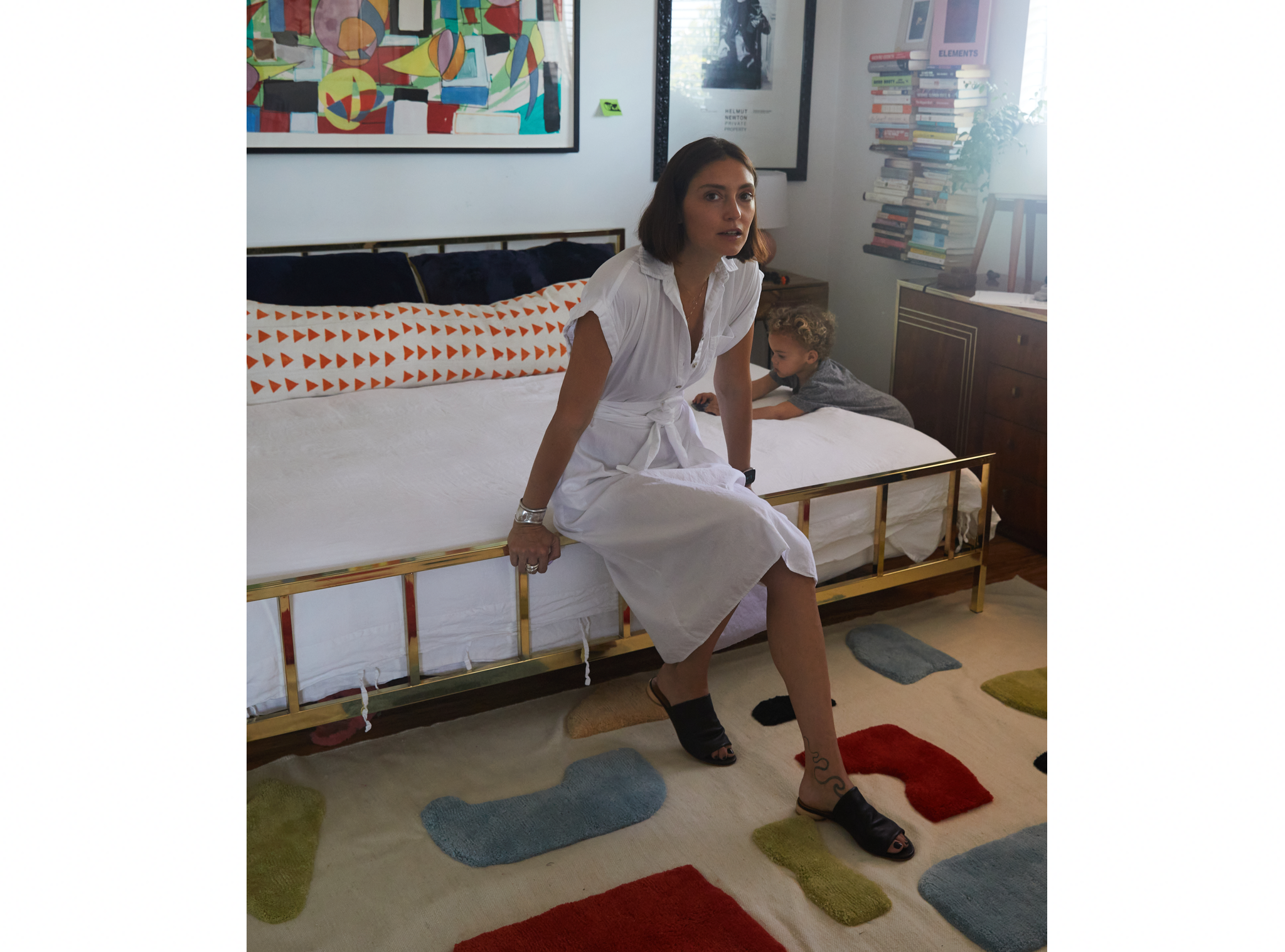 Anna Schilling sitting in her bedroom wearing Coclico slides.  