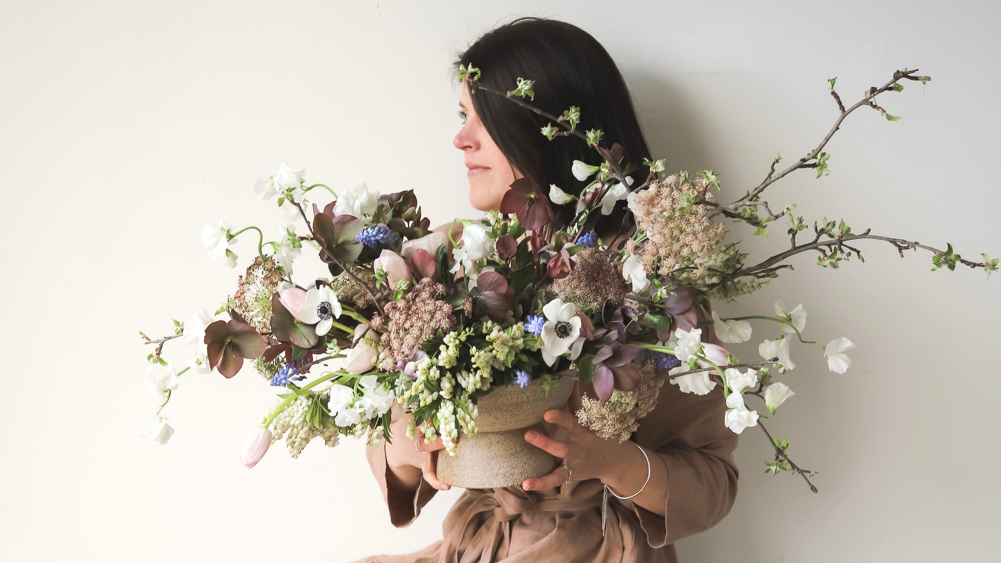 Becky Wallace holding a beautiful, home grown floral arrangement. 