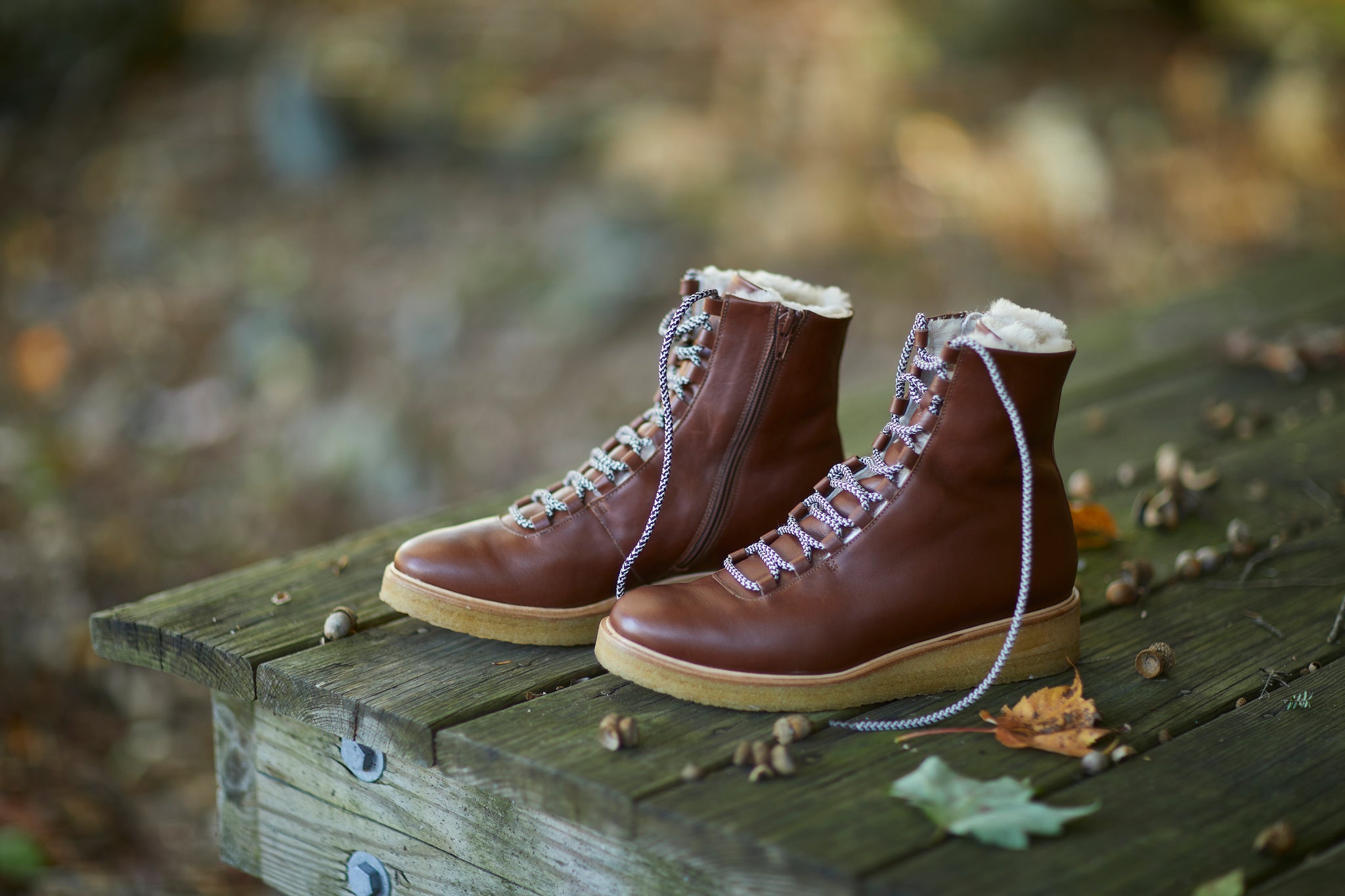 Side view close up of the Coclico Heaven Shearling Boot on a wooden platform.