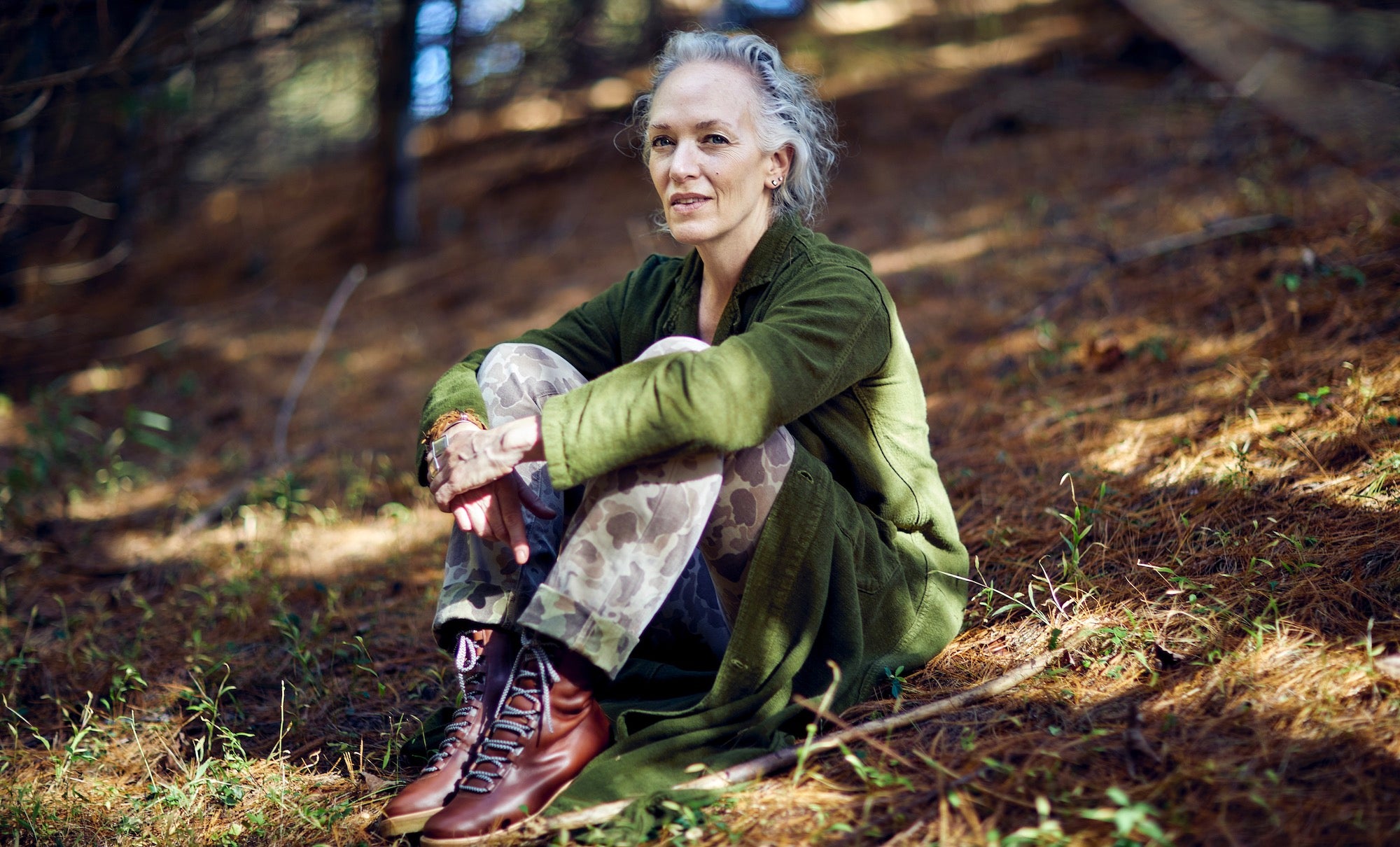 Laura Chávez Silverman sitting in a forest in the Western Catskills.