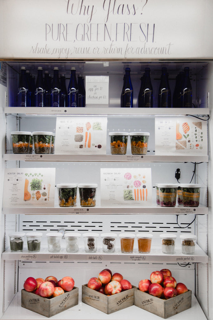 Close up of a fridge in Ancolie displaying delicious fresh food using local and seasonal ingredients served in reusable glass jars.