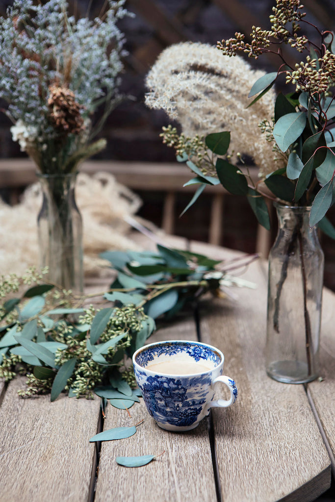 Close up picture of dried floral arrangements on a wooden table. 