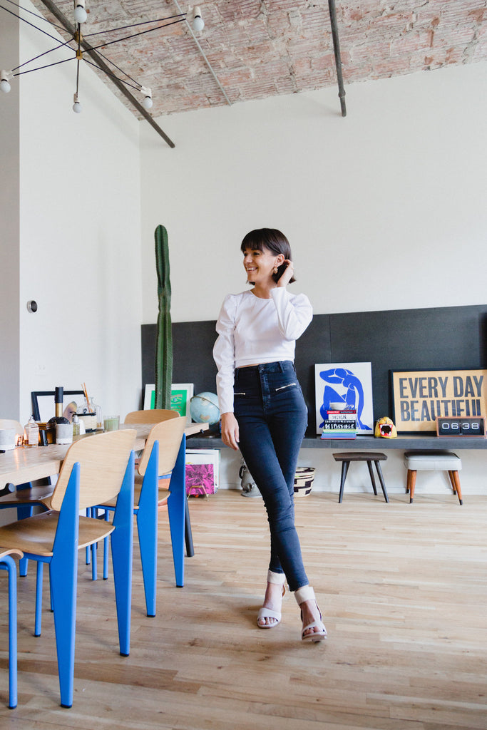 Image of Jessica Walsh standing in her dining room wearing her Coclico Heels. 