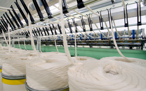 Large cotton spinning machine with barrels of cotton