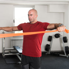 Elite Athelete Using Body Sport Resistance Bands at Home Gym