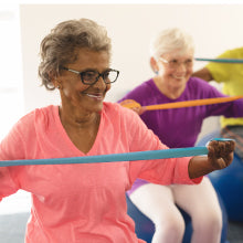 Older Woman with Glasses Using Resistance Bands