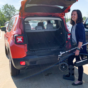 BodyMed Knee Walker - woman placing knee walker in back of car