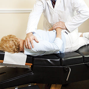 BodyMed Durable Headrest Paper Rolls - patient receiving chiropractic care