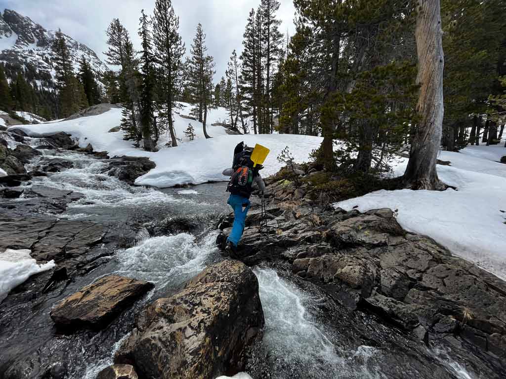The snow is melting quickly so the water was plentiful but moving fast and ice cold! Danny seen here finding the route to cross one of many raging rivers we came across