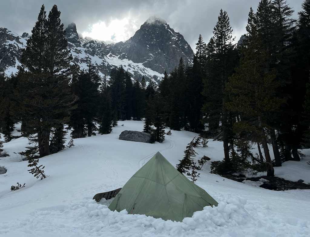  Danny brought a 'mid style' tent to keep our packs lightweight. A floorless tent has its advantages being held up by trekking poles, but by not having a floor the wind can rip through underneath so it's always a good idea to construct walls around the tent