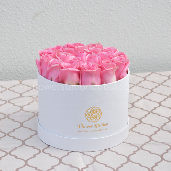 pink roses in white round box