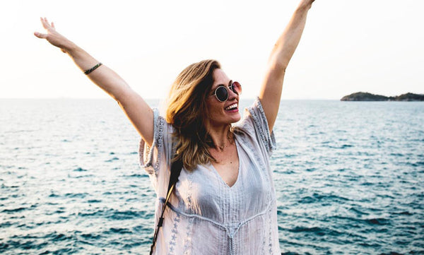 Lady Happy With Arms Up At Beach