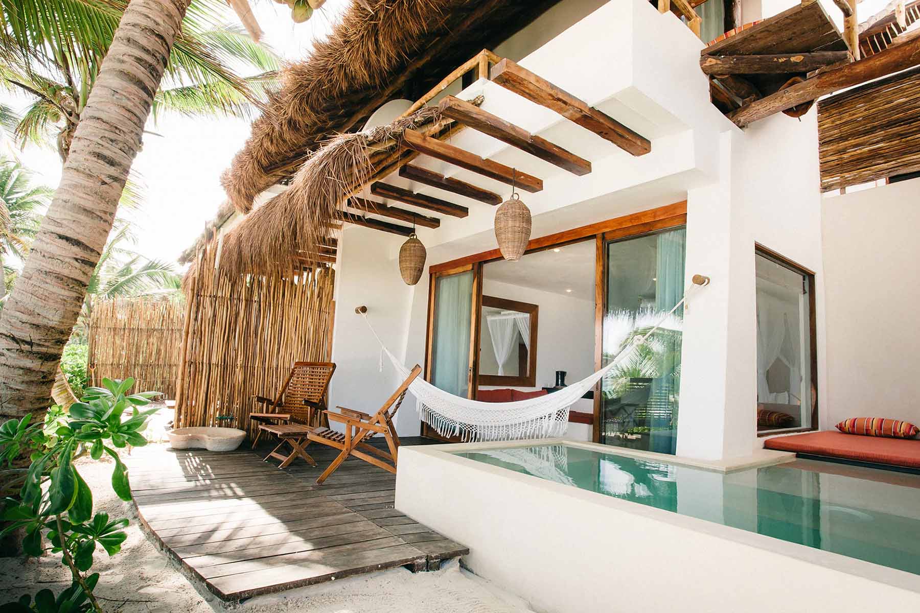 Outside of hotel room in tulum with hammock and mini pool.