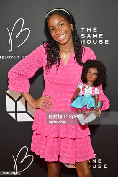 Zoe on red carpet with Bella doll at Beloved Benefit