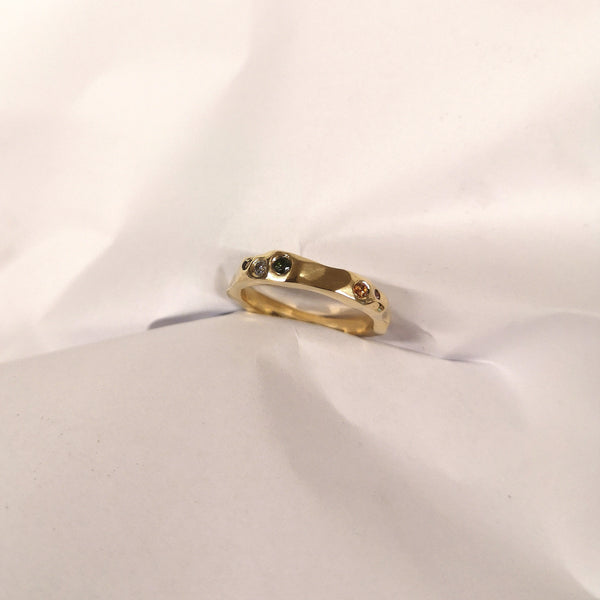 Bespoke band by Laura Nelson made using recycled 18ct gold band with sapphires and tourmalines