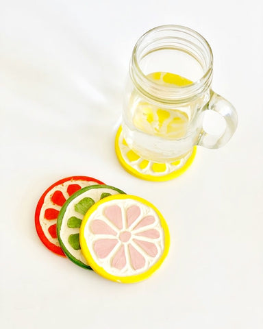 Citrus fruit coasters with glass