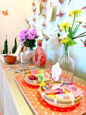 Right half of safe space table, with flowers and bowls of candy