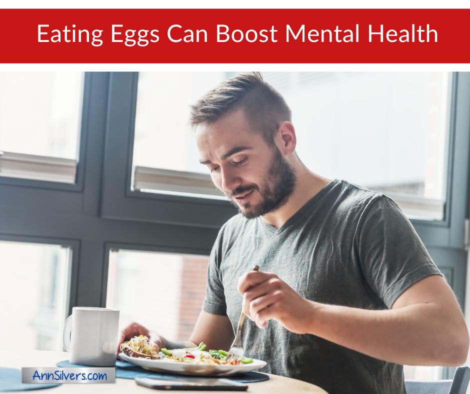 Happy man eating eggs
