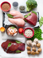 A flatlay image of Iron food such as meat, broccoli, beans, mushroom, and shrimp