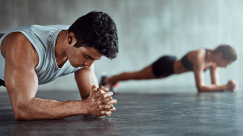 A man and woman doing a plank
