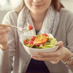 A woman holding a salad bowl