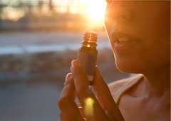 a close-up of a woman holding a small bottle