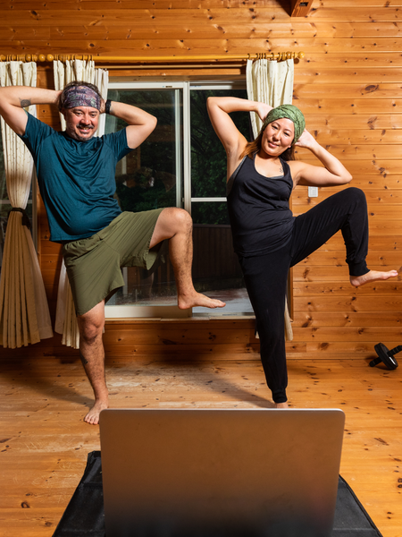 a man and a woman doing a yoga pose