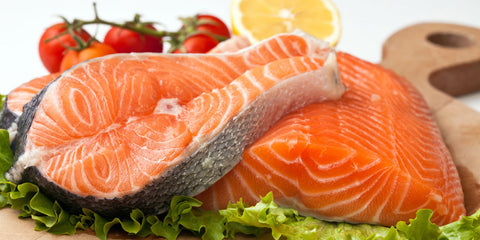 Sliced salmon with surrounded with some vegetables 