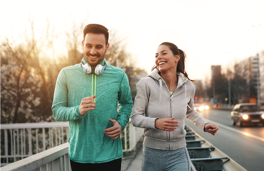 A man and a woman running and smiling