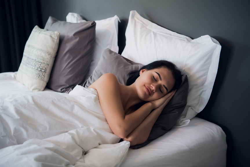 A woman sleeping on a bed