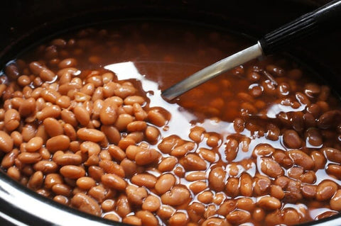 a bowl of beans with a spoon