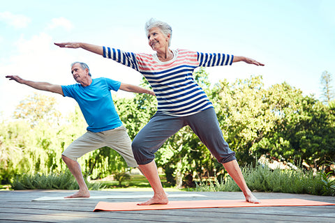 Two Elderly doing a yoga stretch