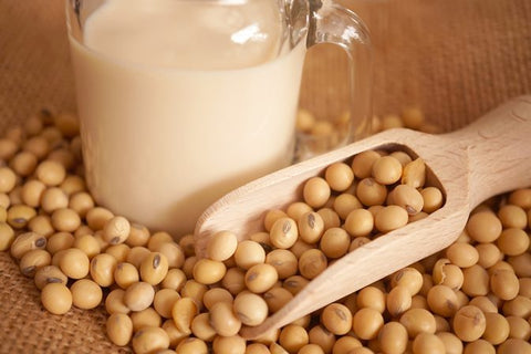 a close-up of soybeans and a glass of milk