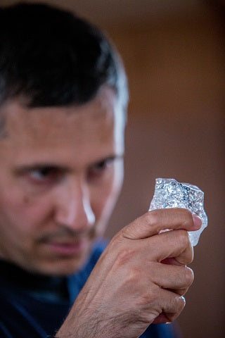 Inspecting an iceberg piece for drinking