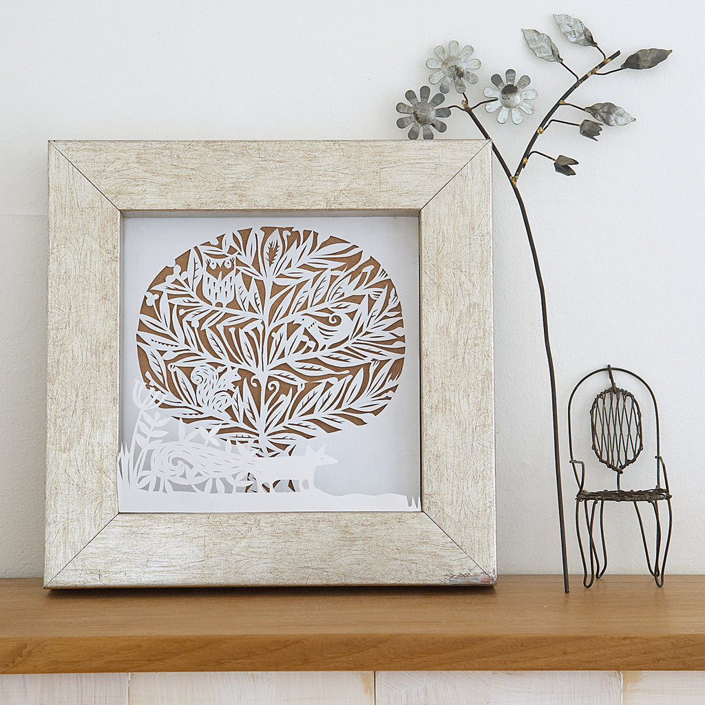 Paper cut winter wonderland scene in picture frame