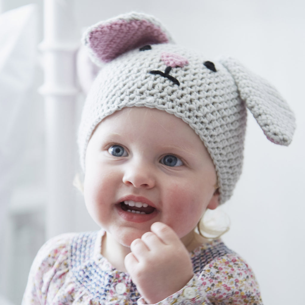 Cute kid wearing crocheted rabbit beanie