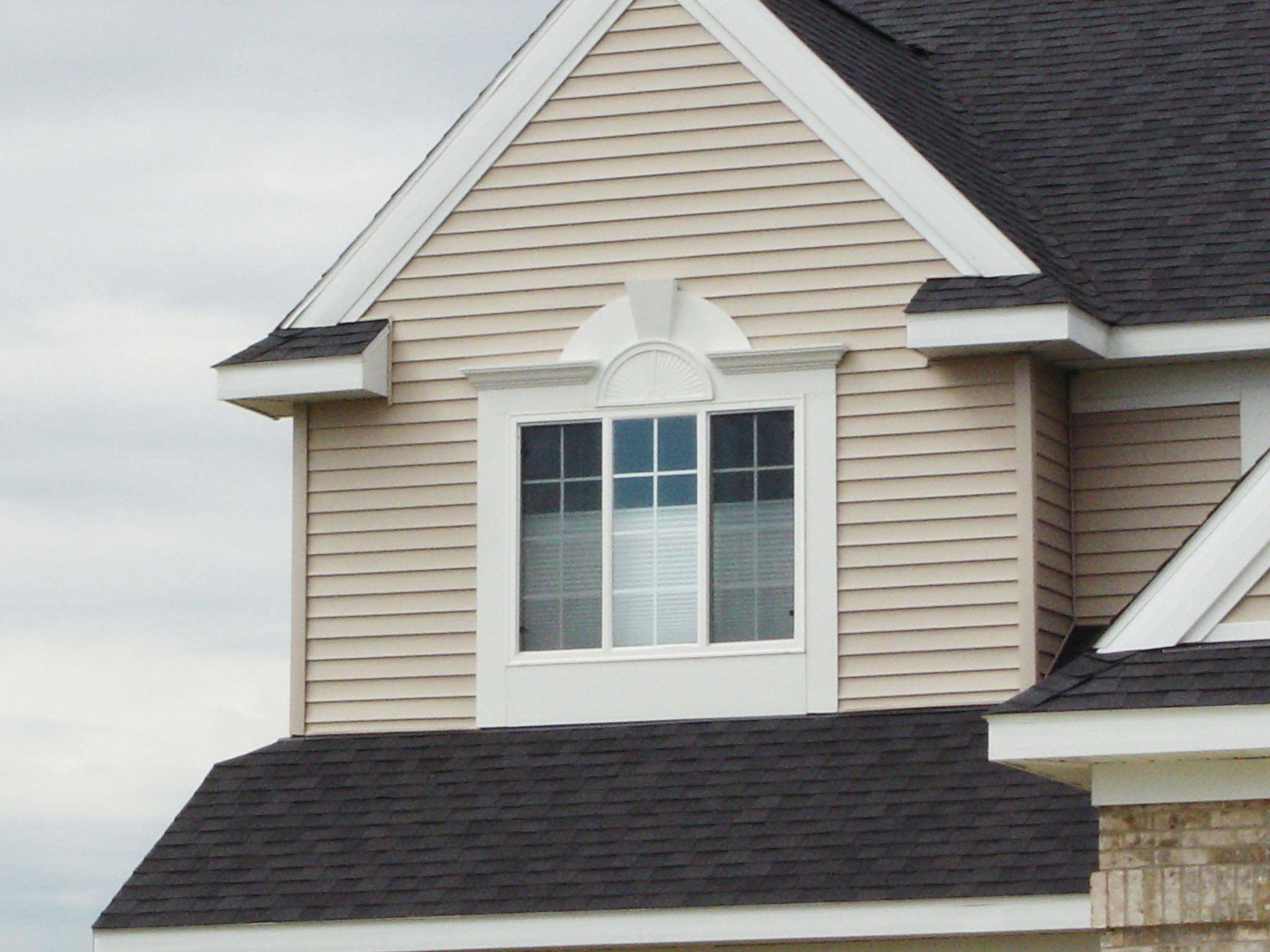 A Half-Round Sunburst Window Pediment with Custom Trim