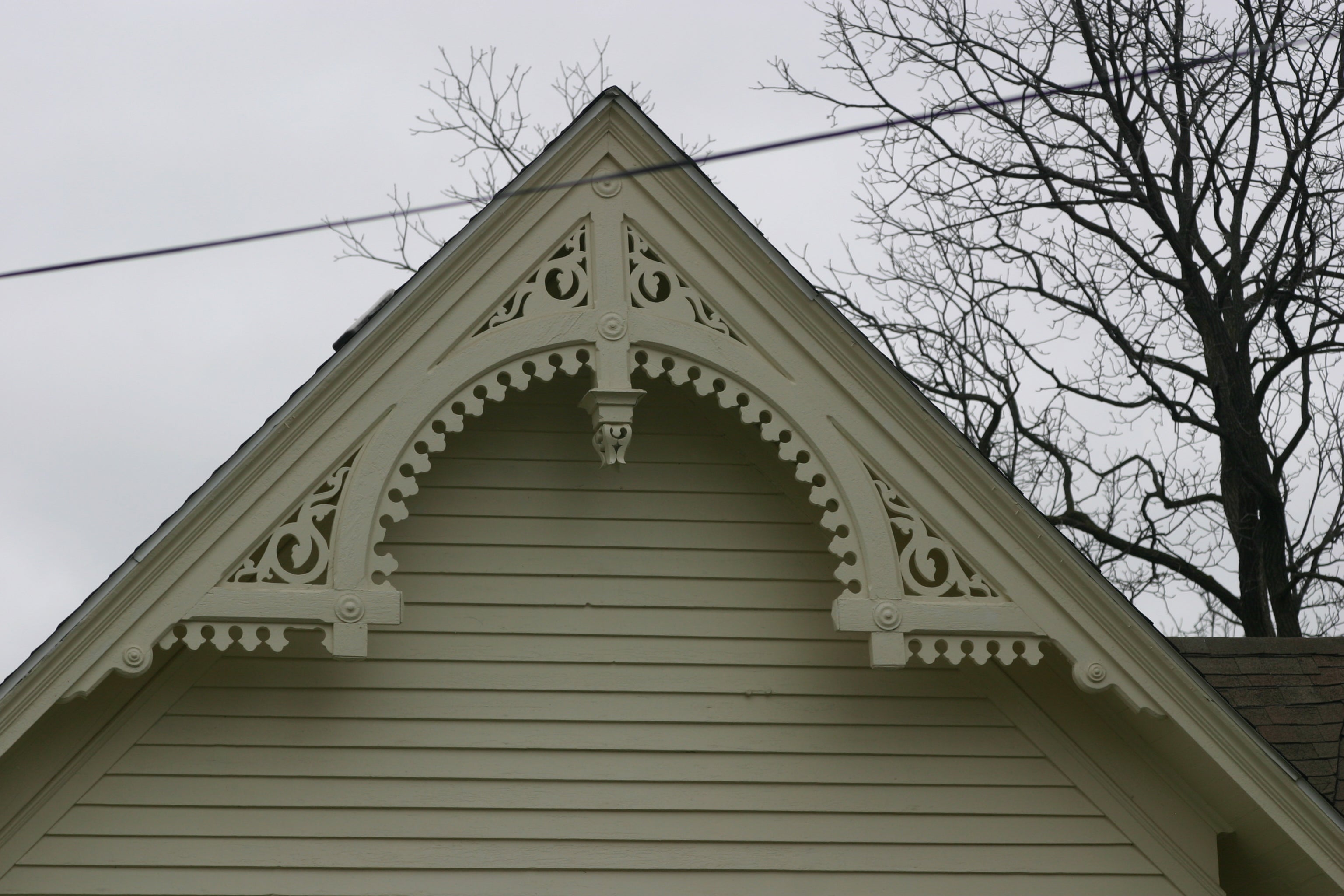 This is a close-up image of white gingerbread gable trim.